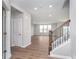 Spacious foyer with open staircase and hardwood flooring for a welcoming entrance at 8445 Morgan Ln, Zionsville, IN 46077