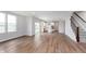 Open concept living room featuring modern kitchen, hardwood floors, natural light, and a staircase at 8445 Morgan Ln, Zionsville, IN 46077