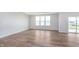 Open living room with wood-look floors, large windows, and natural light at 8445 Morgan Ln, Zionsville, IN 46077