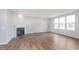 Bright living room with wood-look floors, large windows, and a fireplace at 8445 Morgan Ln, Zionsville, IN 46077