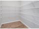 An organized walk-in closet equipped with wire shelving and wood-look floors at 8445 Morgan Ln, Zionsville, IN 46077
