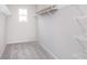 A walk-in closet includes wire shelving, carpet, and a window providing natural light at 8445 Morgan Ln, Zionsville, IN 46077