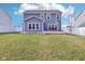 Rear exterior view of a two-story home with a well-manicured lawn and fenced backyard at 856 Parker Ln, Westfield, IN 46074