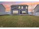 Back exterior view of a two-story home with deck and grassy, fenced yard, at dusk at 856 Parker Ln, Westfield, IN 46074