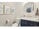 Chic half bathroom with shiplap accent wall, modern vanity, round mirror, and stylish décor at 856 Parker Ln, Westfield, IN 46074