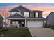 Charming two-story home with stone accents, a landscaped yard, and a spacious two car garage at 856 Parker Ln, Westfield, IN 46074