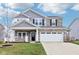 Charming two-story home with stone accents, a landscaped yard, and a spacious two car garage at 856 Parker Ln, Westfield, IN 46074