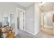 Hallway with a neutral color palette, carpet flooring, and view of chair with a large mirror at 856 Parker Ln, Westfield, IN 46074