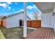 This backyard features a wood fence, grass, a wood deck, and a detached garage at 1020 Calvary St, Indianapolis, IN 46203