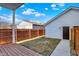 This backyard features a wood fence, grass, a wood deck, and access to the garage at 1020 Calvary St, Indianapolis, IN 46203