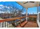 The balcony features wood flooring and railing, with a great view of the neighborhood at 1020 Calvary St, Indianapolis, IN 46203