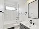 The bathroom features white subway tile, black trim, and a modern vanity and plumbing fixtures at 1020 Calvary St, Indianapolis, IN 46203