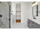 Elegant bathroom with tiled shower, vanity with sleek countertop, and walk-in closet at 1020 Calvary St, Indianapolis, IN 46203