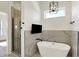 The bathroom features a walk-in shower and soaking tub under a modern light fixture and wall-mounted TV at 1020 Calvary St, Indianapolis, IN 46203