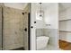 This bathroom features a luxurious walk-in shower, a soaking tub, and a modern chandelier at 1020 Calvary St, Indianapolis, IN 46203