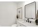 Half bath with a modern vanity, stylish mirror, and decorative art at 1020 Calvary St, Indianapolis, IN 46203