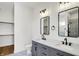 Primary bathroom featuring dual vanities, modern mirrors, and tiled floors at 1020 Calvary St, Indianapolis, IN 46203