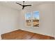 This bedroom features hardwood floors, white walls, a ceiling fan, and a double window at 1020 Calvary St, Indianapolis, IN 46203