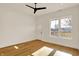Bedroom with hardwood floors, a ceiling fan, large windows, and exterior door at 1020 Calvary St, Indianapolis, IN 46203