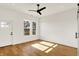 A serene bedroom with hardwood floors, a ceiling fan, and natural light at 1020 Calvary St, Indianapolis, IN 46203