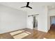 Bedroom with hardwood floors, fan, and a modern sliding barn door to bathroom at 1020 Calvary St, Indianapolis, IN 46203
