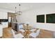 Bright dining area adjacent to the kitchen, featuring modern table and sleek chairs at 1020 Calvary St, Indianapolis, IN 46203