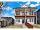 Charming two-story duplex with individual balconies, contrasting trim, and sidewalk at 1020 Calvary St, Indianapolis, IN 46203