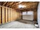 Unfinished garage with exposed wood framing, concrete floor, and a white door ready for personalization and storage at 1020 Calvary St, Indianapolis, IN 46203