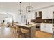 Open-concept kitchen with stainless steel appliances, island with seating, and a modern aesthetic at 1020 Calvary St, Indianapolis, IN 46203