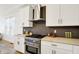 Bright kitchen featuring white cabinetry, stainless steel appliances, and stylish backsplash at 1020 Calvary St, Indianapolis, IN 46203