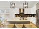 Bright kitchen island with seating, pendant lights, and modern finishes that connects to the dining at 1020 Calvary St, Indianapolis, IN 46203