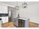 Stylish kitchen island with stainless appliances and white countertop, highlighted by pendant lighting at 1020 Calvary St, Indianapolis, IN 46203