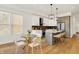 Modern kitchen with stainless steel appliances, island seating, and adjacent dining area at 1020 Calvary St, Indianapolis, IN 46203