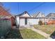 Backyard view featuring a detached garage in a residential neighborhood at 1129 Church St, Indianapolis, IN 46225