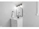 Bathroom featuring a white vanity with a marble countertop and updated lighting at 1129 Church St, Indianapolis, IN 46225