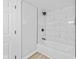 Clean bathroom featuring white tile surround, vinyl floors, and modern fixtures at 1129 Church St, Indianapolis, IN 46225