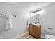 Bathroom featuring a wood vanity with a marble countertop and updated lighting fixtures at 1129 Church St, Indianapolis, IN 46225