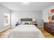Bedroom featuring neutral walls, wood floors and a large window for ample natural light at 1129 Church St, Indianapolis, IN 46225