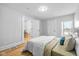 Bedroom featuring neutral colored walls, hardwood floors, and two entryways at 1129 Church St, Indianapolis, IN 46225
