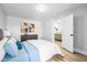 Bedroom with light-colored walls, hardwood floors and a view into the living room at 1129 Church St, Indianapolis, IN 46225