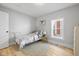 Bedroom with a hardwood floor, neutral walls, and a large window allowing natural light at 1129 Church St, Indianapolis, IN 46225