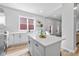 Bright kitchen featuring white cabinets, quartz countertops, and stylish open shelving at 1129 Church St, Indianapolis, IN 46225