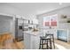 Modern kitchen with stainless steel appliances, island with seating, and bright natural light at 1129 Church St, Indianapolis, IN 46225