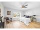 Serene bedroom with hardwood floors, ceiling fan, and ample natural light at 1129 Church St, Indianapolis, IN 46225