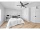 Bright and airy bedroom featuring hardwood floors, a ceiling fan, and three entry points at 1129 Church St, Indianapolis, IN 46225