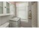 Bright bathroom featuring a vanity with a marble countertop and subway tile in the shower at 117 N Leland St, Fortville, IN 46040