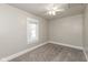 Bedroom with carpeted floors, neutral colors, and a ceiling fan at 117 N Leland St, Fortville, IN 46040