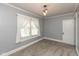Bedroom with neutral walls, carpeted floors, and a door leading to another room at 117 N Leland St, Fortville, IN 46040