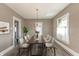 Cozy dining room features a dark wood table with seating for six and stylish light fixture at 117 N Leland St, Fortville, IN 46040
