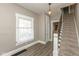 Entryway with hardwood floors and staircase, providing access to upper levels at 117 N Leland St, Fortville, IN 46040